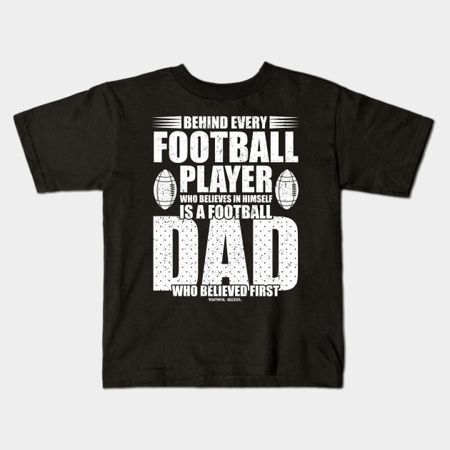 Behind Every Football Player Is A Football Dad Kids T-Shirt by YouthfulGeezer